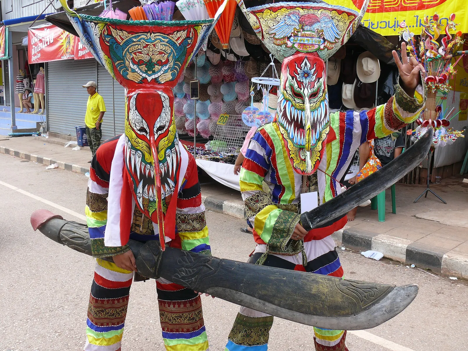 Colourful painted Phi Ta Khon masks with long noses and wide grins