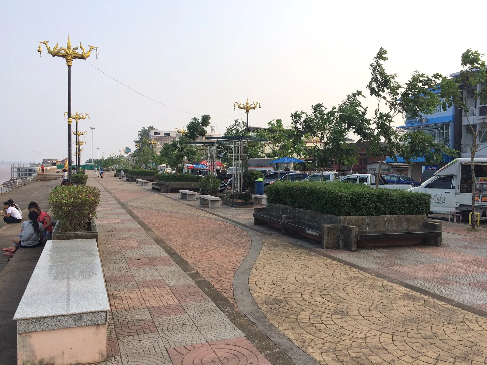The paved riverside promenade of Nakhon Phanom with lamps and benches beside the Mekong