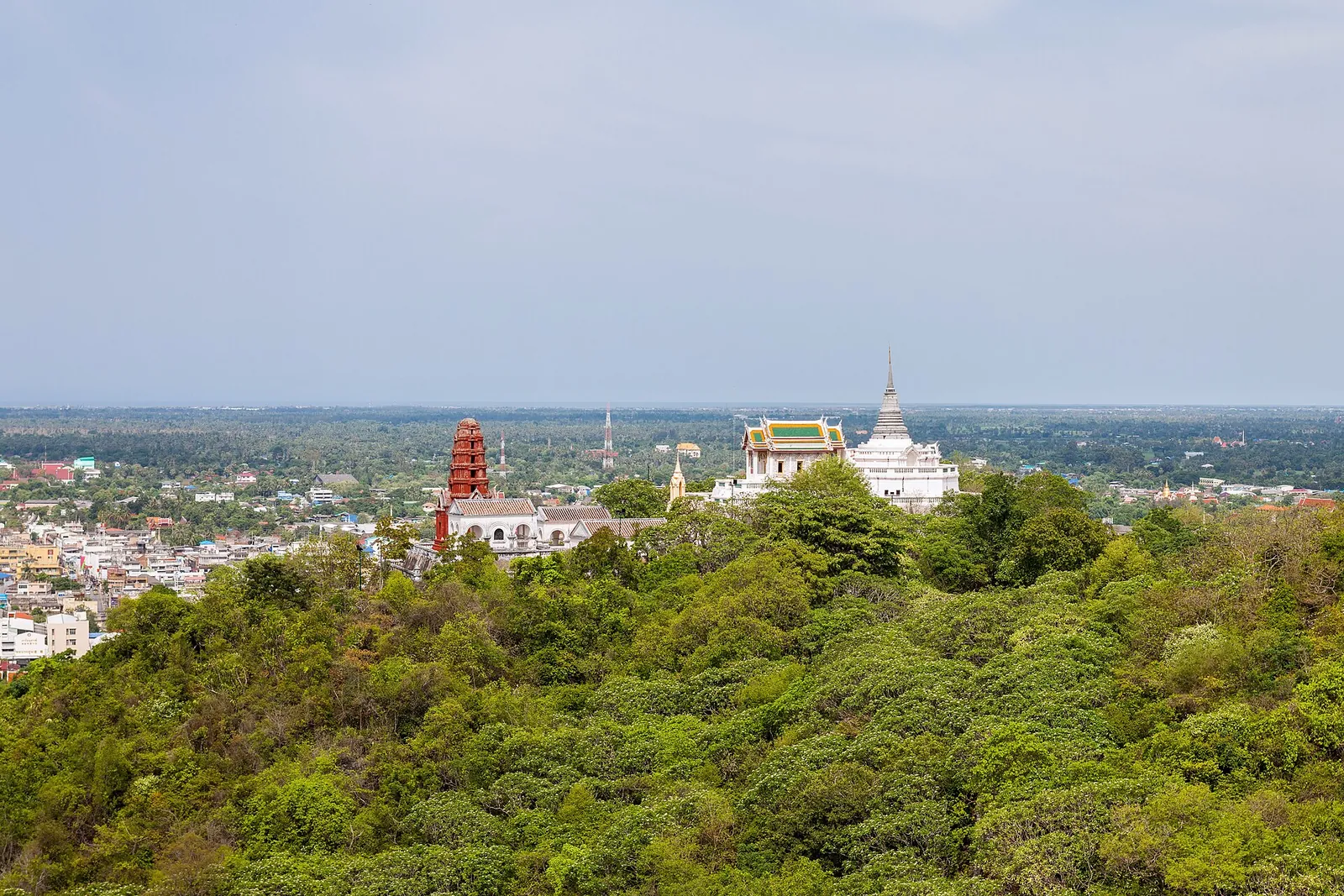 View from Khao Wang over forested slopes to Phetchaburi town and a white chedi