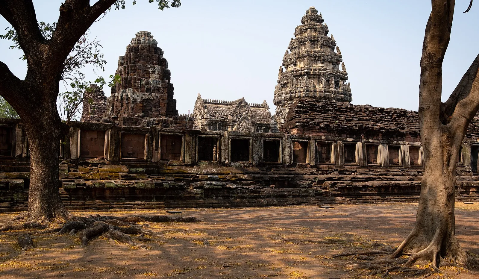 The towers and galleries of Prasat Hin Phimai framed by trees
