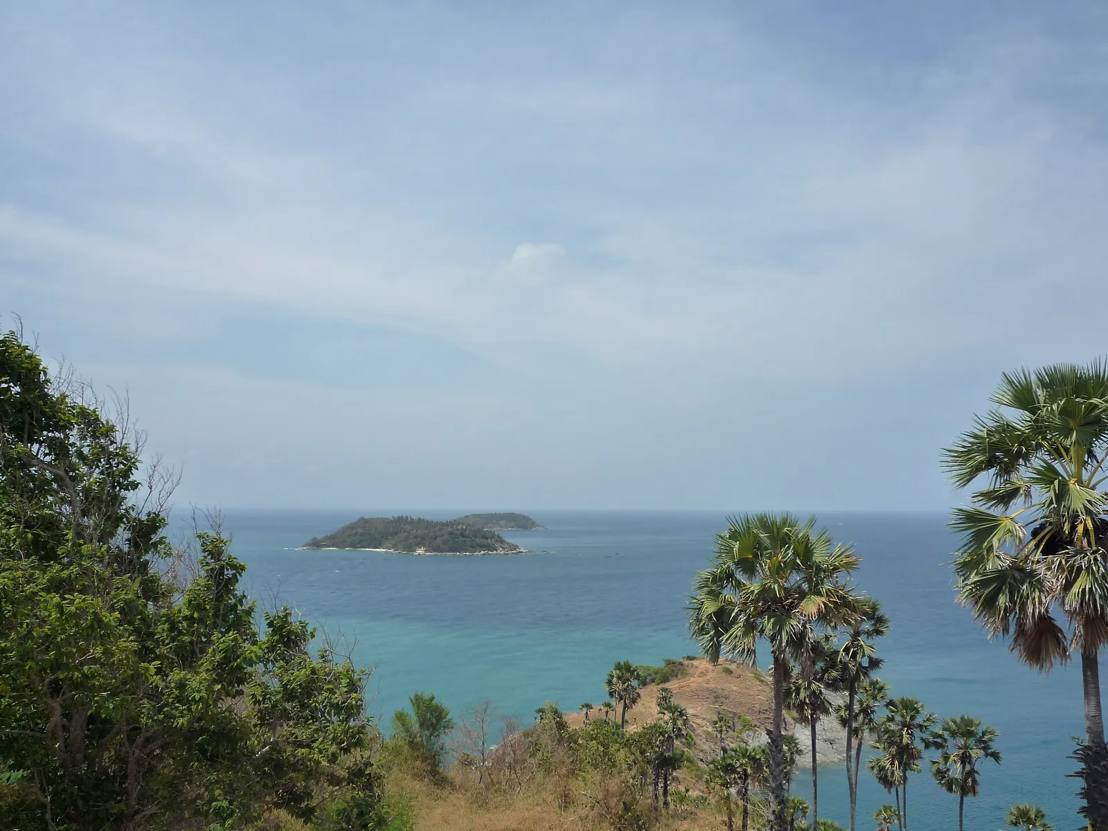 Palm trees and a small island off Promthep Cape seen from the headland
