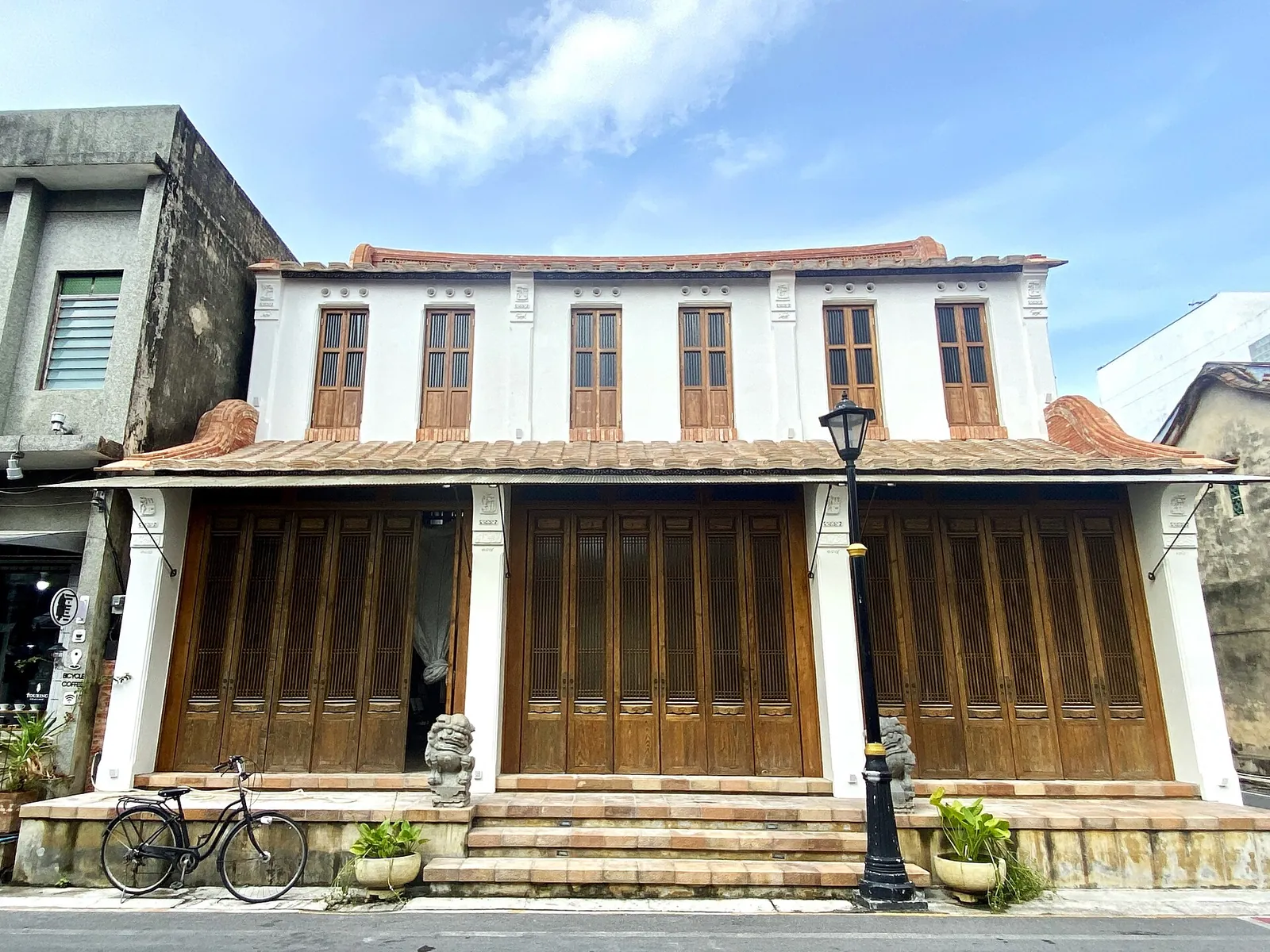 A restored wooden-shuttered house with a tiled roof in Songkhla Old Town