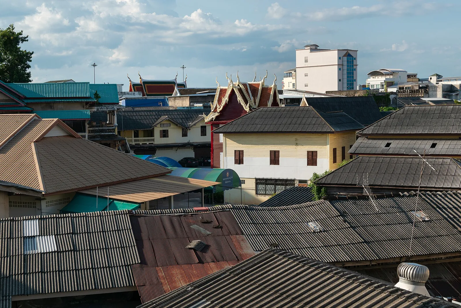 Rooftops of Surat Thani town around Wat Sai under a cloudy sky