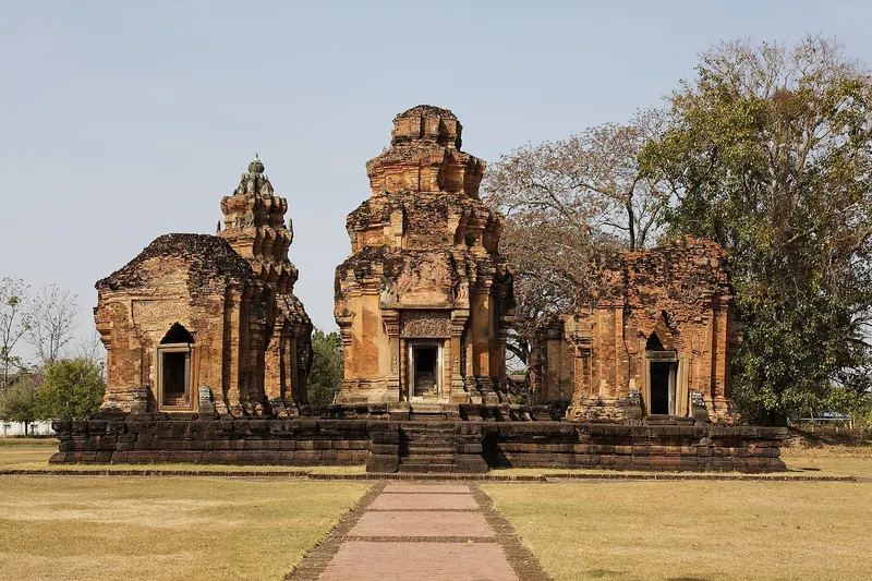 The five brick towers of Prasat Sikhoraphum on a raised base at the end of a path