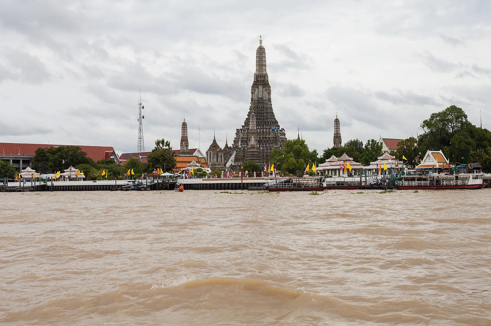 Wat Arun's central prang seen across the Chao Phraya River in Bangkok