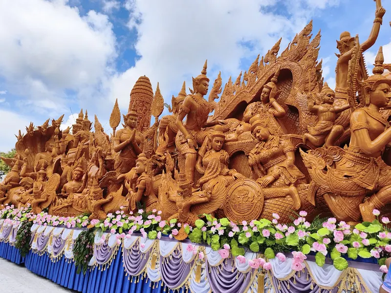 A huge carved wax float of figures and mythical creatures on parade in the Ubon Candle Festival