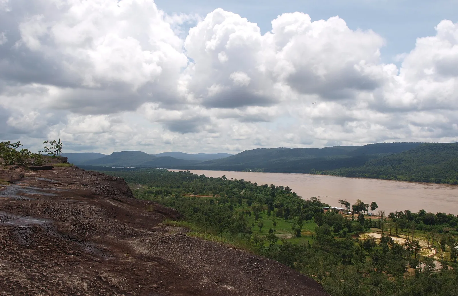 View from the Pha Taem cliffs over forest to the wide Mekong and the hills of Laos
