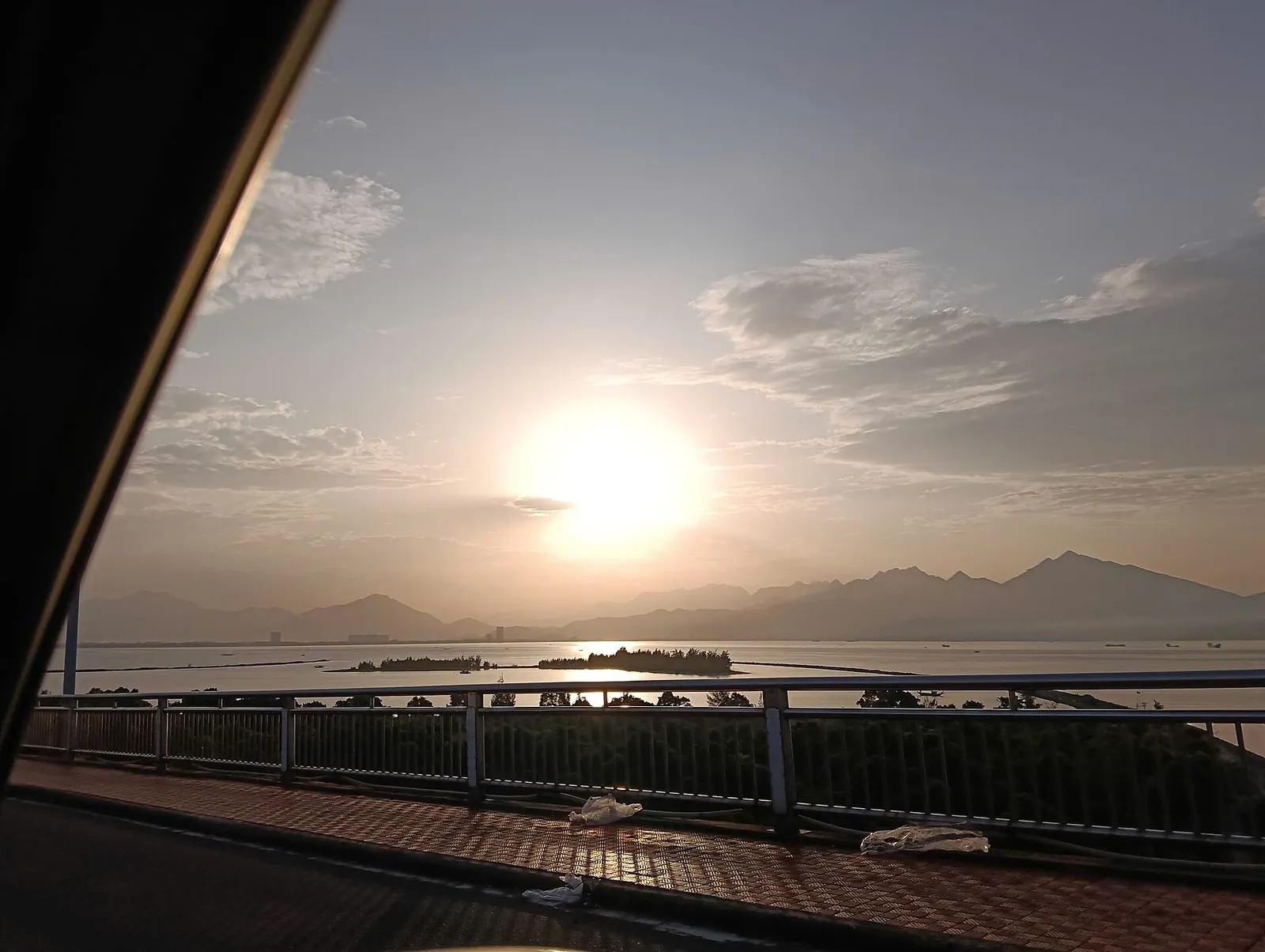 The silhouette of the Bach Ma mountain range across the water at sunset, seen from the Thuan Phuoc bridge in Da Nang