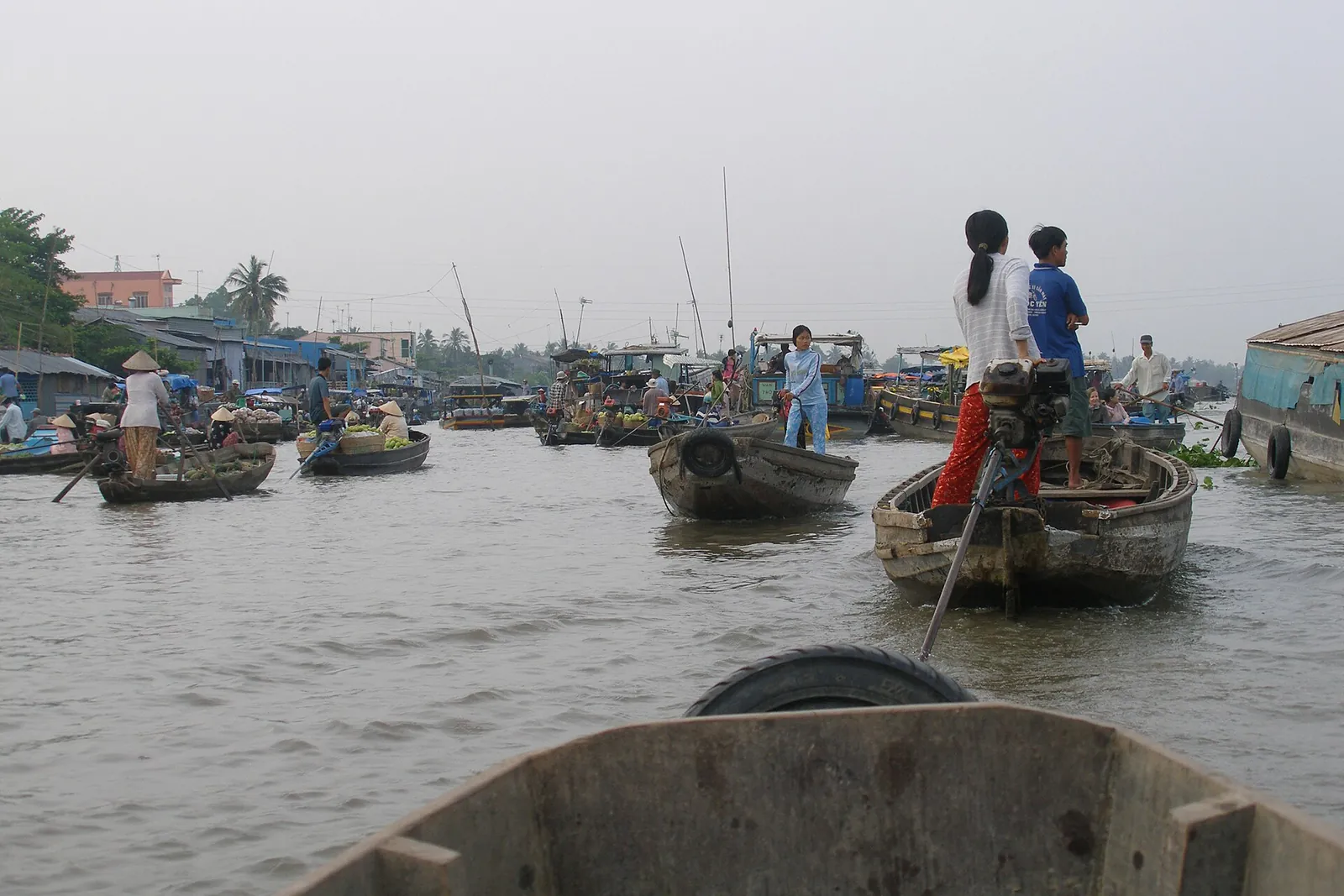 Small wooden boats at the Cai Rang floating market on a river near Can Tho in the Mekong Delta