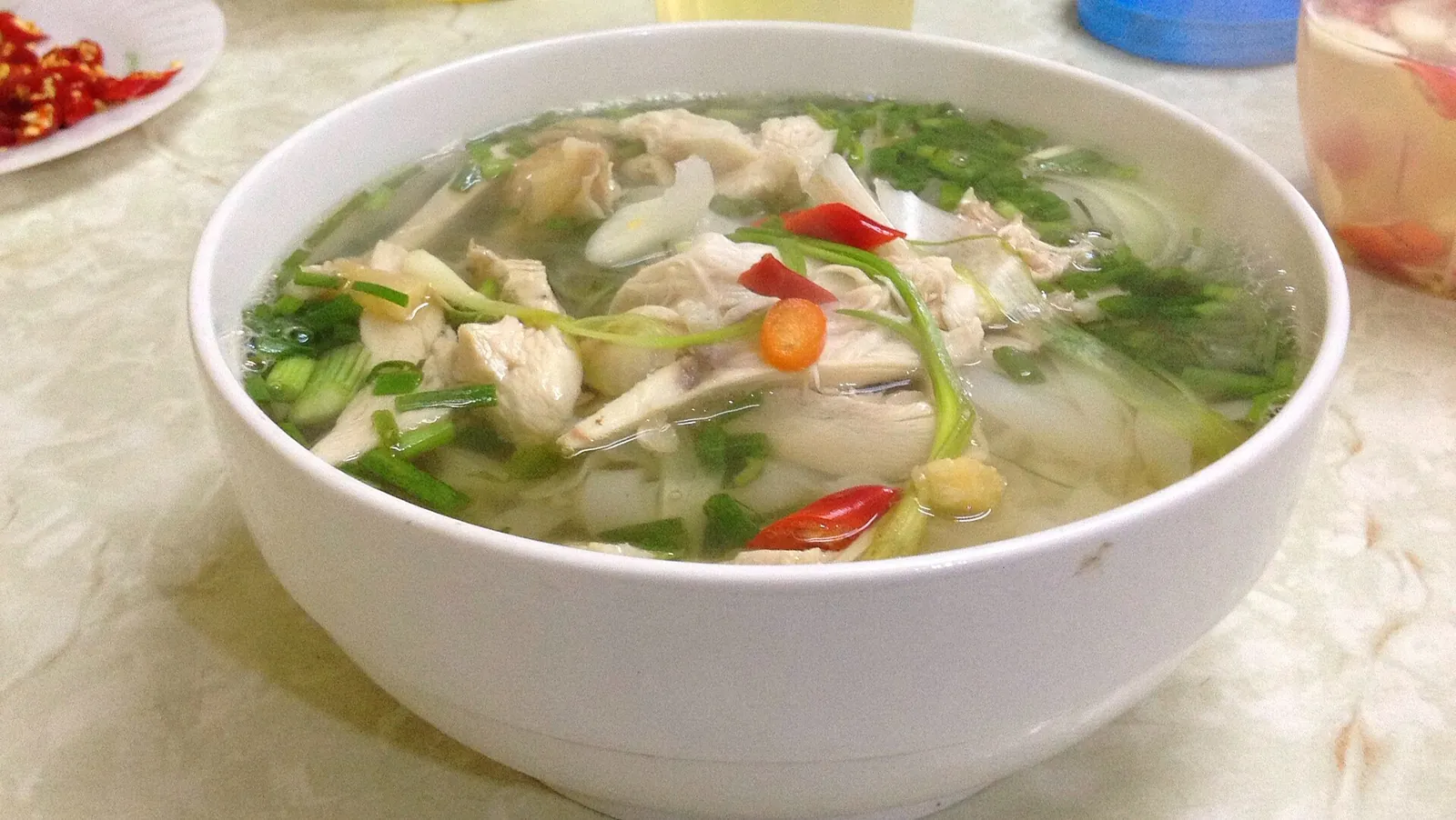 Bowl of pho ga, chicken noodle soup with herbs and chilli, served in Hanoi