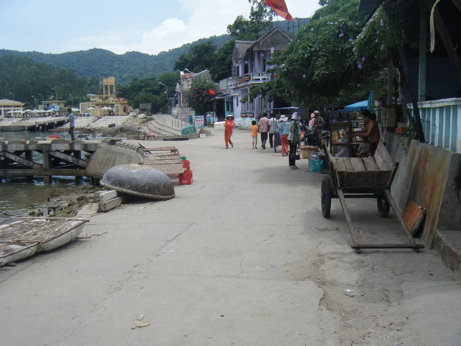 Seafront lane in a Cham Islands village with basket boats pulled up beside it
