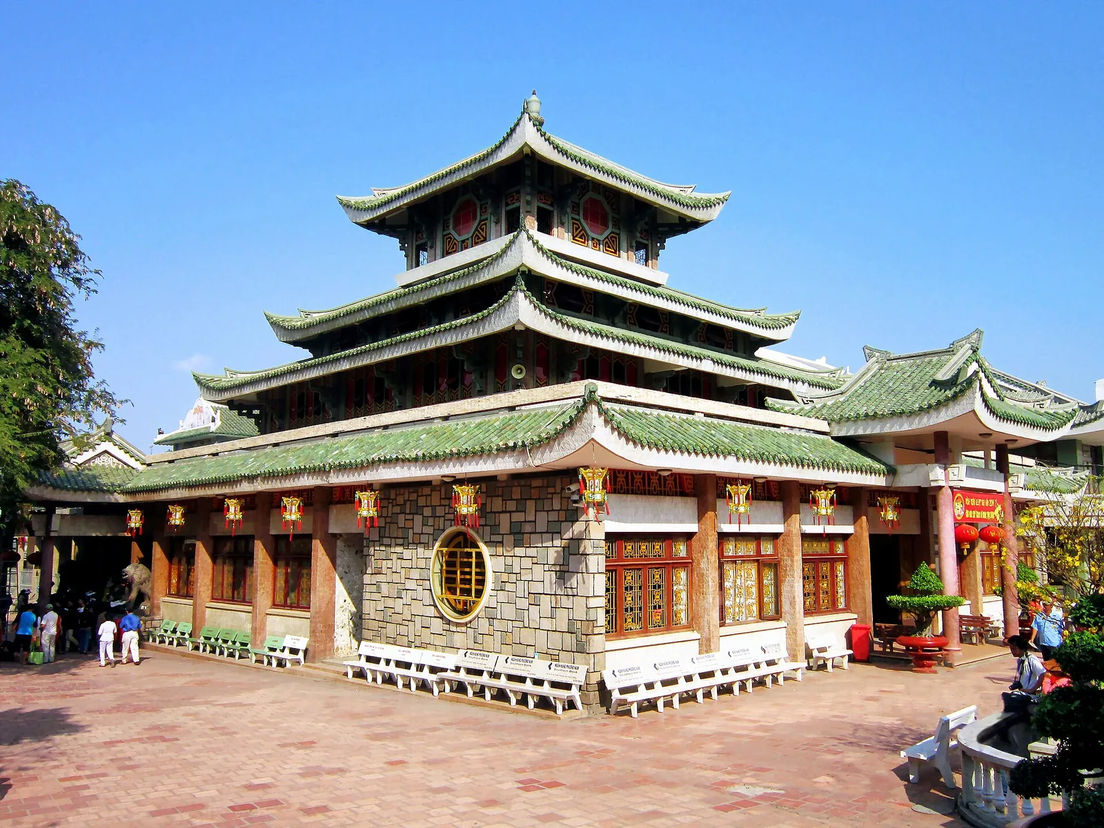 The tiered green-roofed temple of Ba Chua Xu at the foot of Sam Mountain under a blue sky