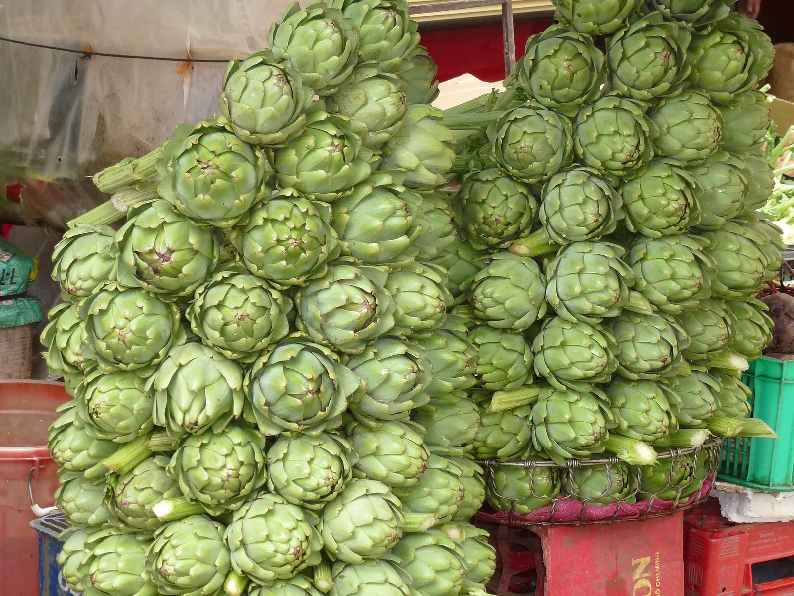 Piles of fresh green artichokes on a stall in Da Lat Market
