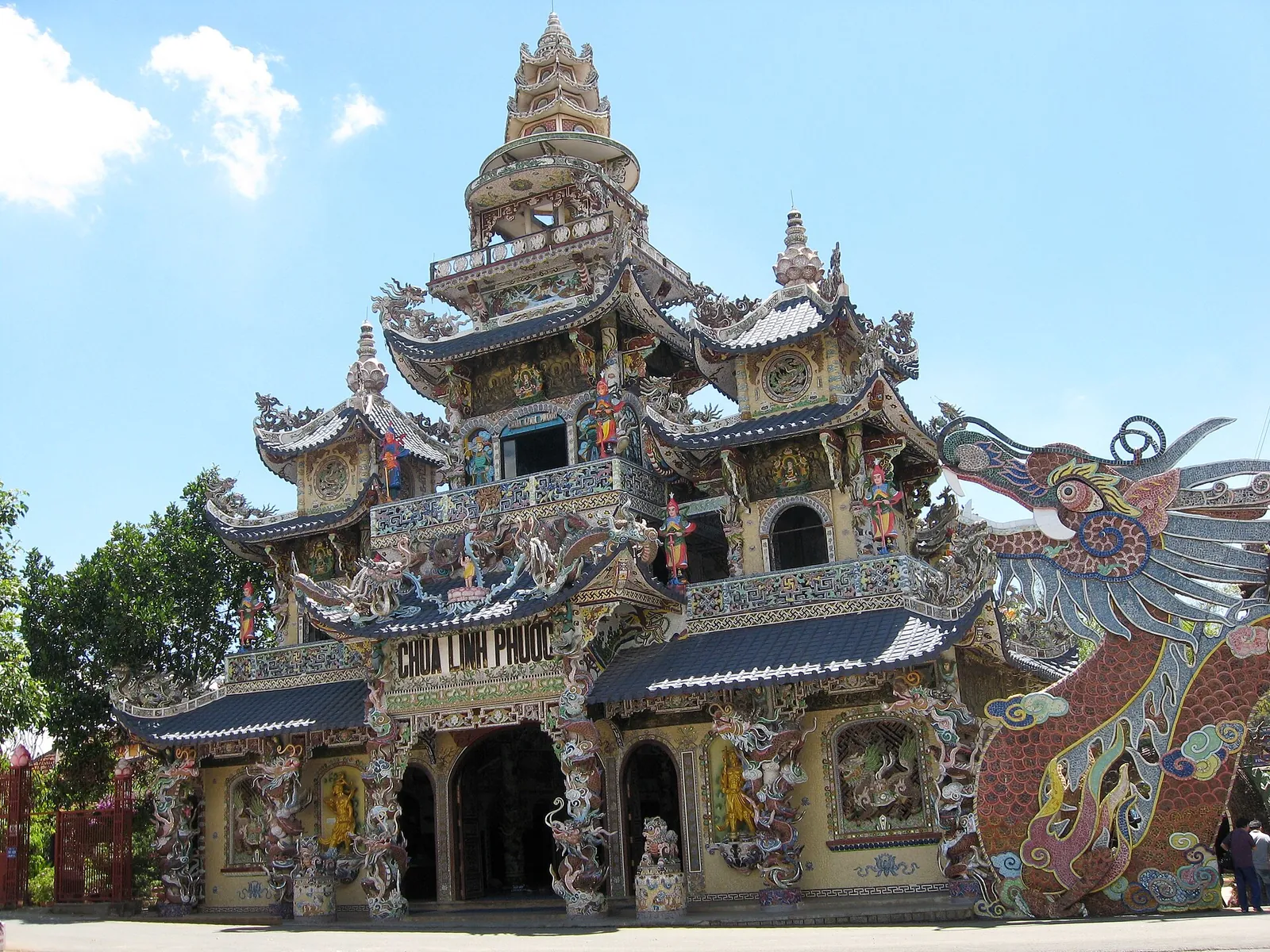 The ornate multi-tiered tower of Linh Phuoc Pagoda in Trai Mat, decorated with mosaic and a dragon sculpture