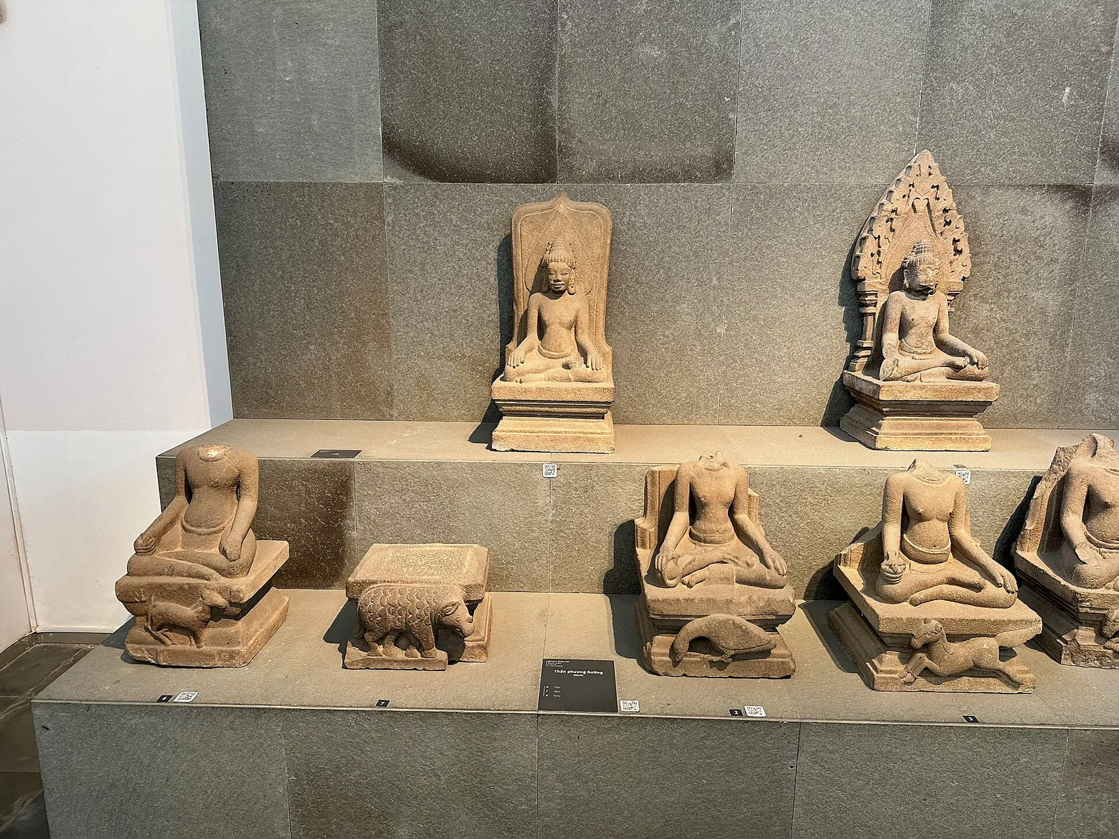 Sandstone Cham sculptures of Hindu deities displayed on stepped plinths at the Museum of Cham Sculpture in Da Nang