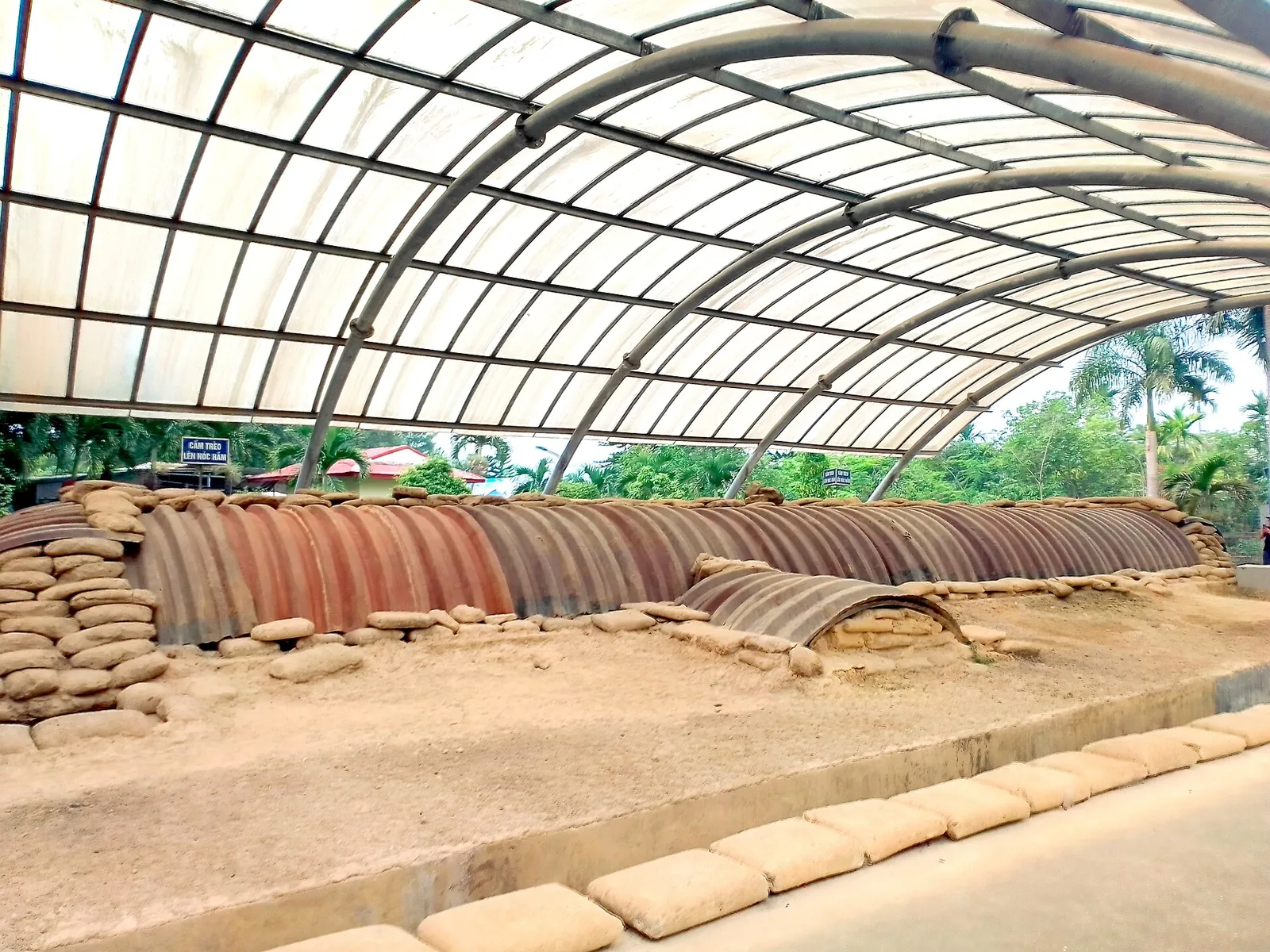 The sandbagged, corrugated-iron roof of the French command bunker under a modern protective canopy