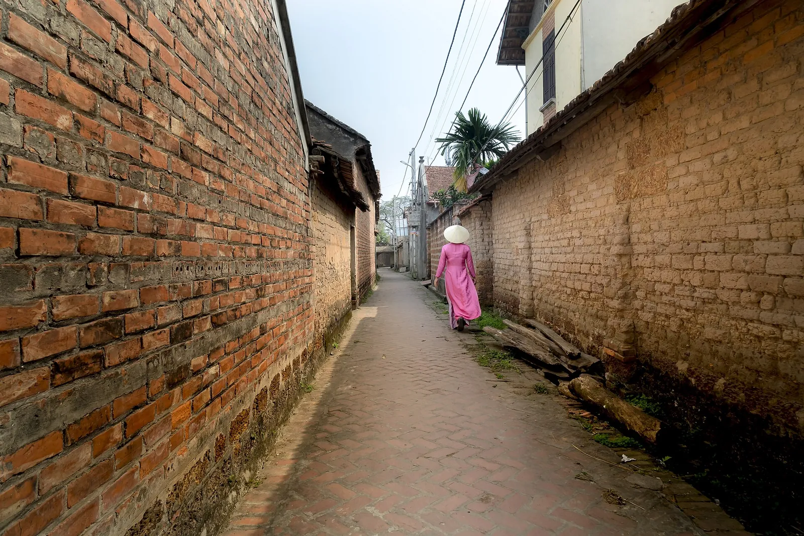 Narrow lane between high old walls in Duong Lam ancient village