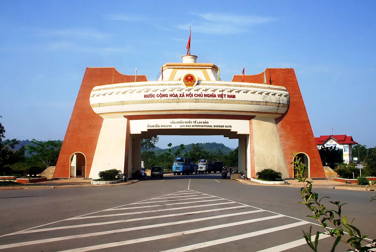 Red and cream arched gateway of the Lao Bao international border gate on the road from Laos in Quang Tri province
