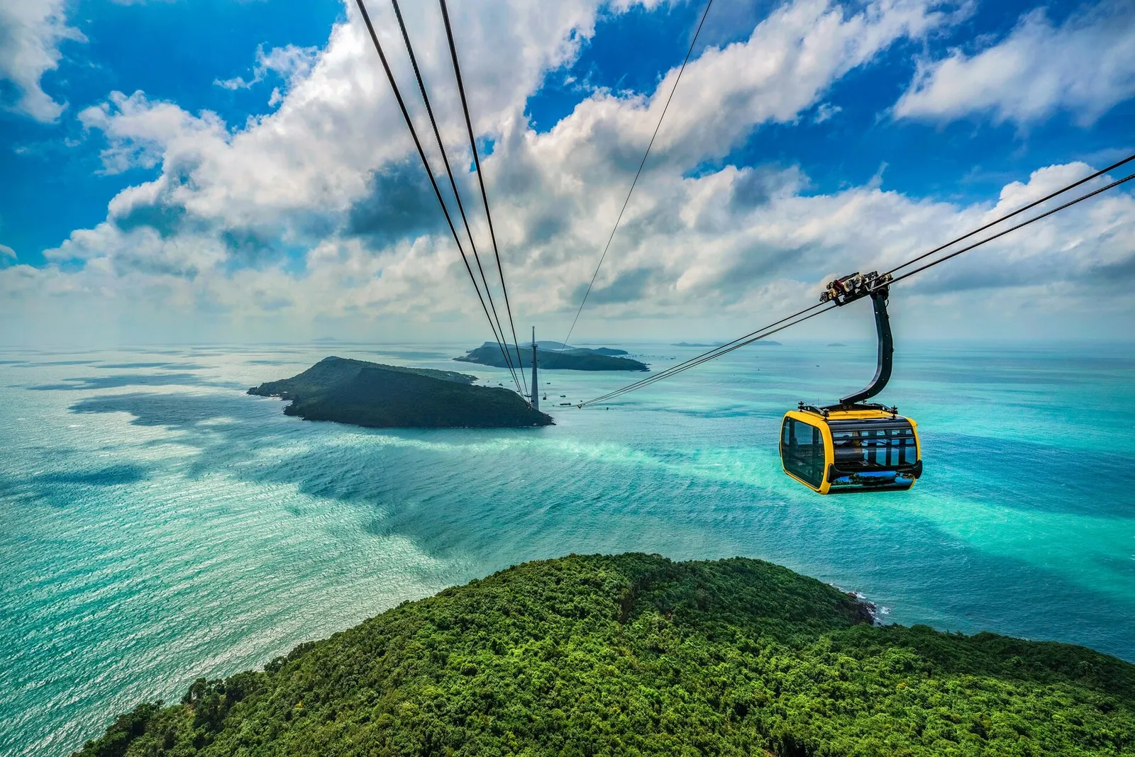 Hon Thom cable car gondola crossing turquoise sea between green islands off southern Phu Quoc
