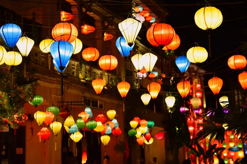 Colourful silk lanterns strung above a street in Hoi An's Ancient Town at night