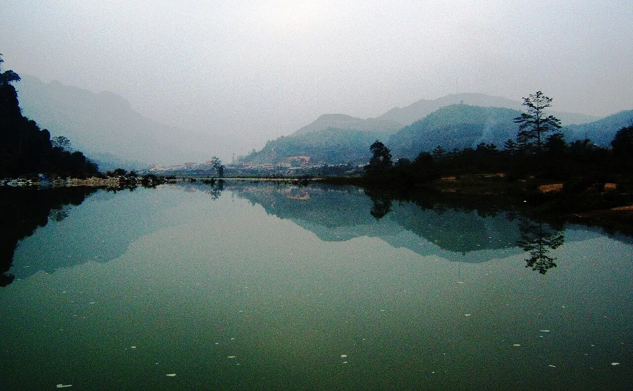 The calm Gam River reflecting forested hills in Yen Phu commune, Bac Me