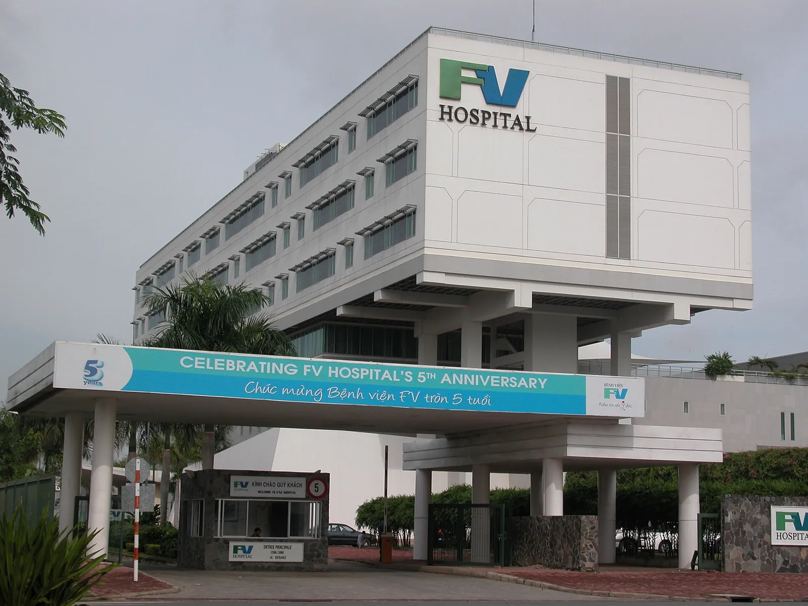 The white main building of FV Hospital in District 7, Ho Chi Minh City, with the FV logo and a covered entrance