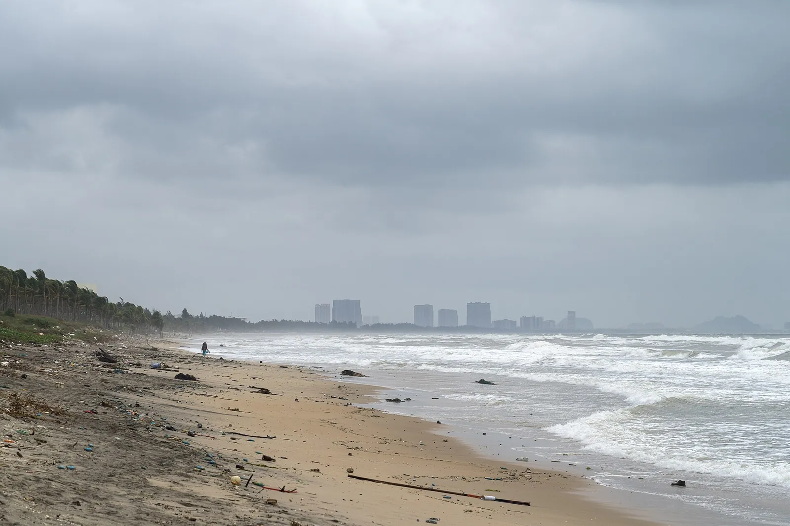 An Bang Beach near Hoi An under an overcast November sky, with surf and a long empty stretch of sand