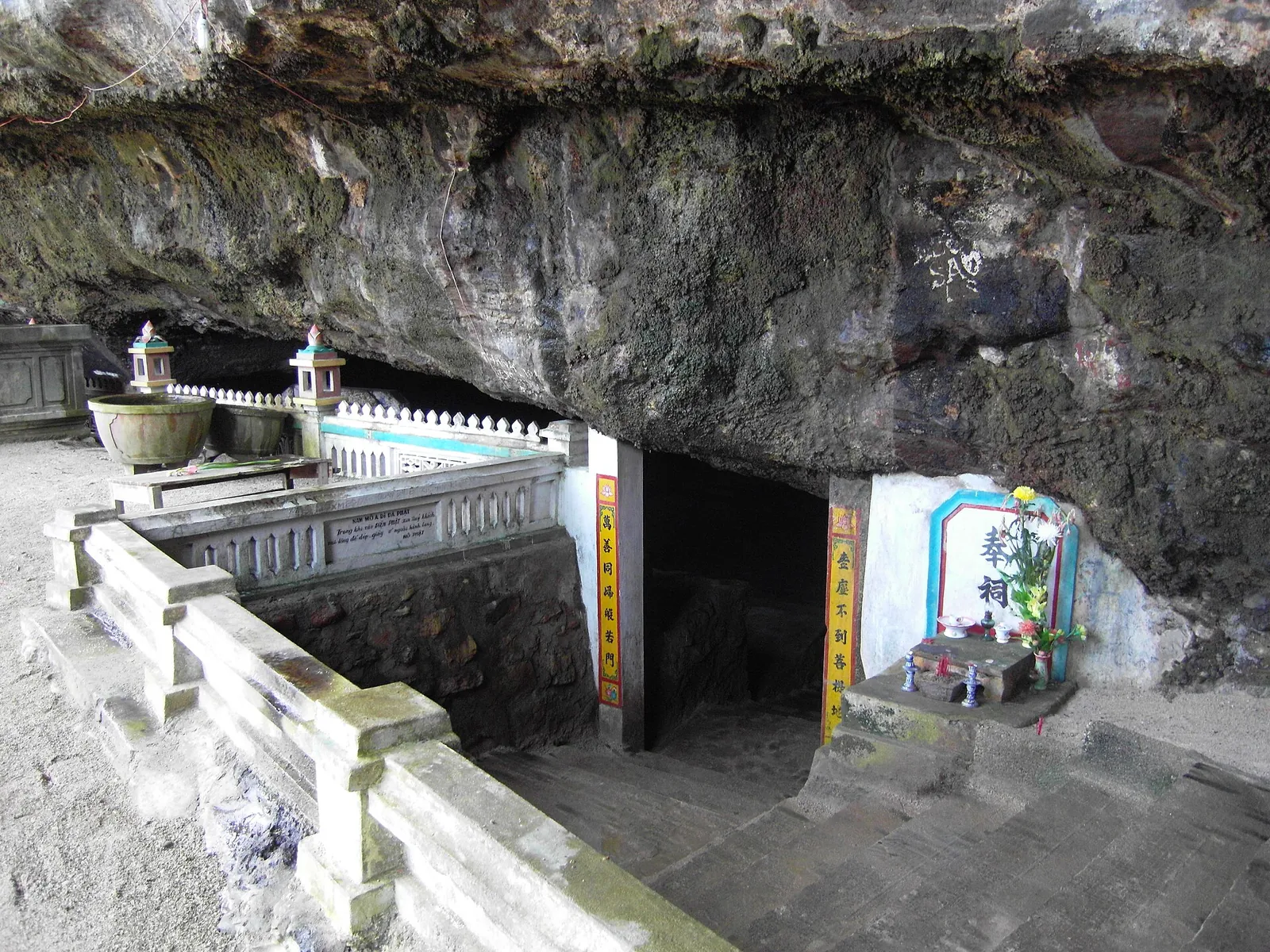 Shrine with altars set beneath a large overhang of volcanic rock on Ly Son