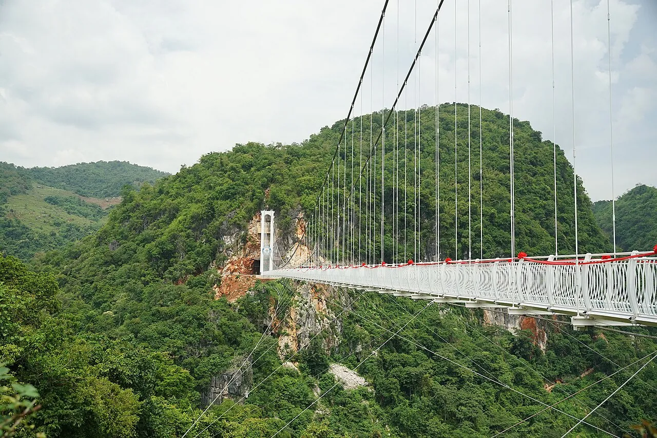 The Bach Long glass-bottomed suspension bridge strung across a forested gorge in Moc Chau