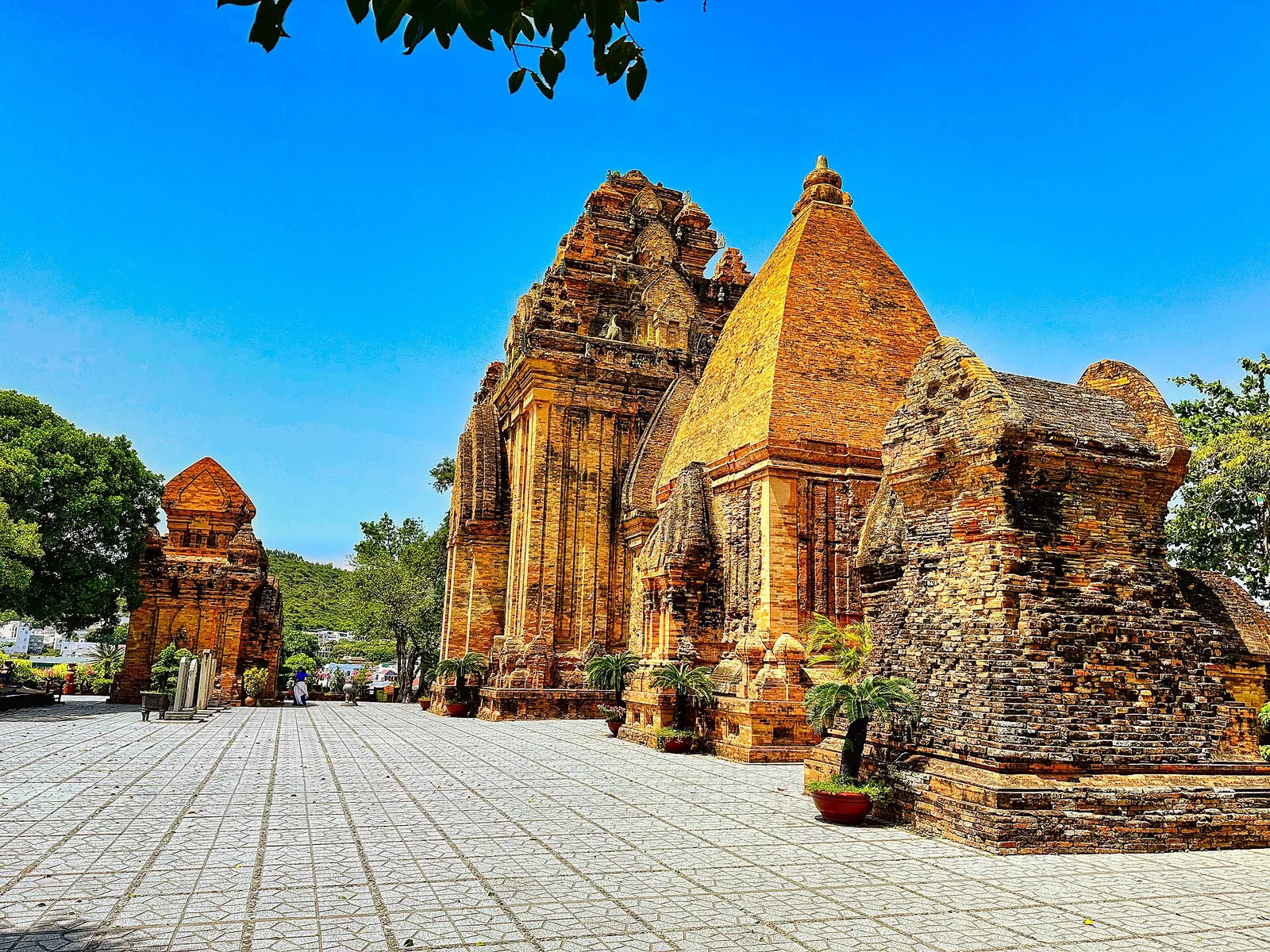 Red-brick Cham towers of the Po Nagar temple complex in Nha Trang under a bright blue sky