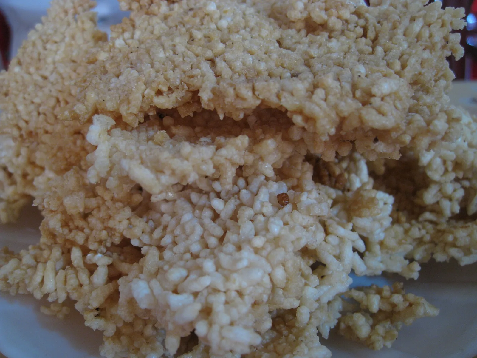 A pile of golden, crisp rice crust (com chay) on a plate