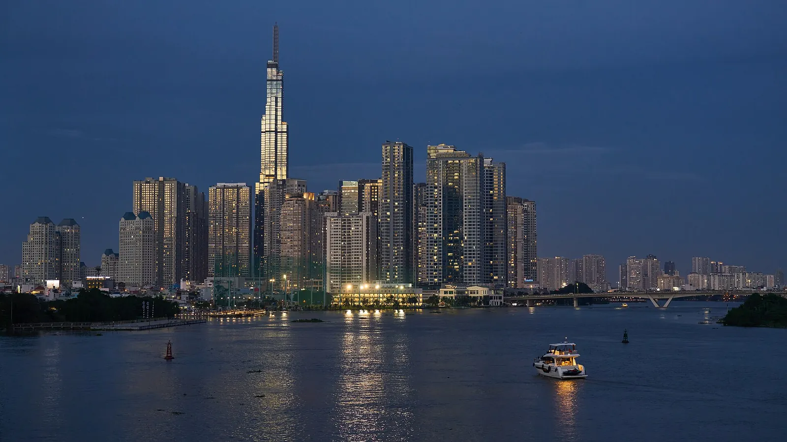 Ho Chi Minh City skyline with the Landmark 81 tower reflected in the Saigon River at blue hour