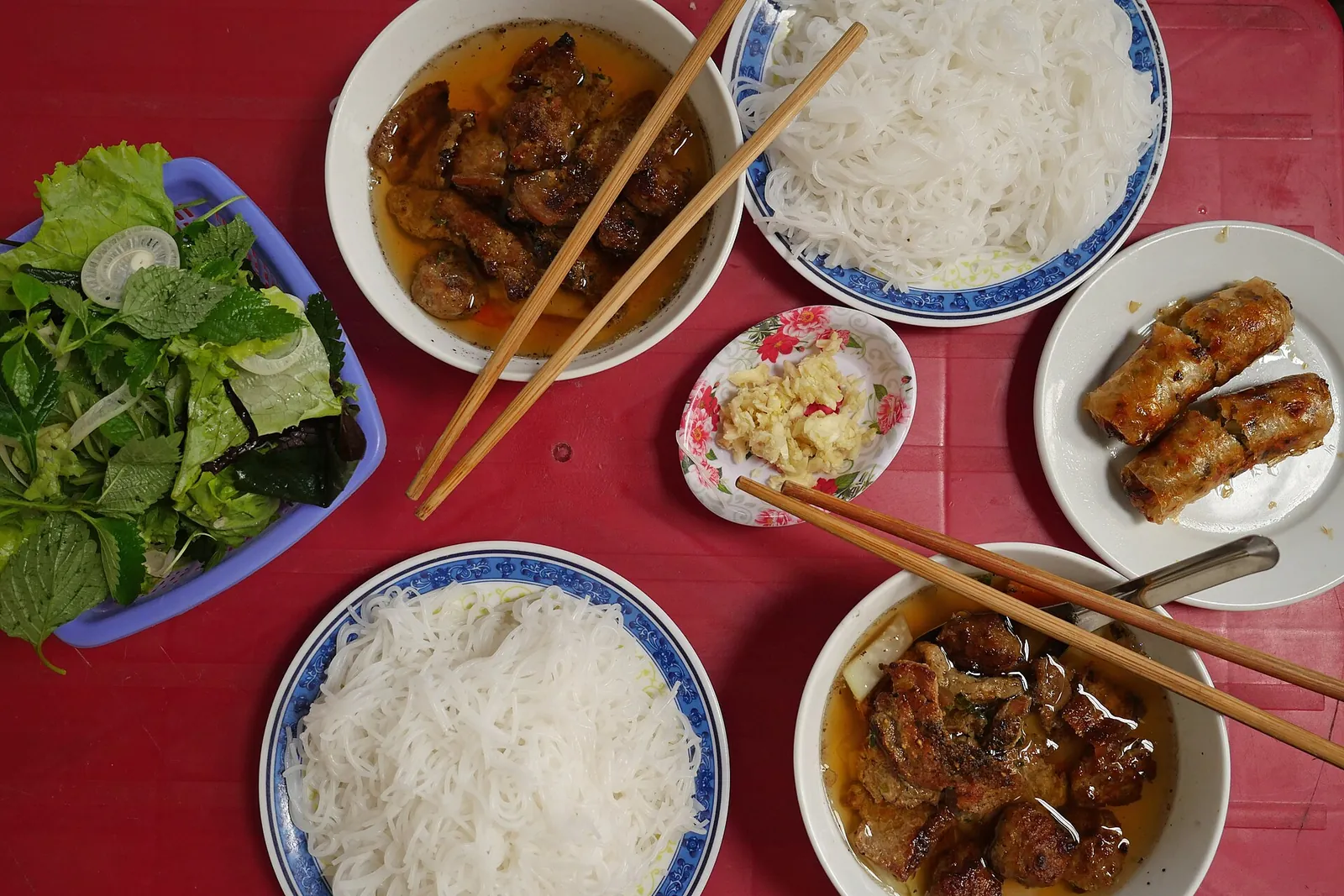 Bun cha in Hanoi: grilled pork in dipping broth with rice noodles, herbs and fried spring rolls