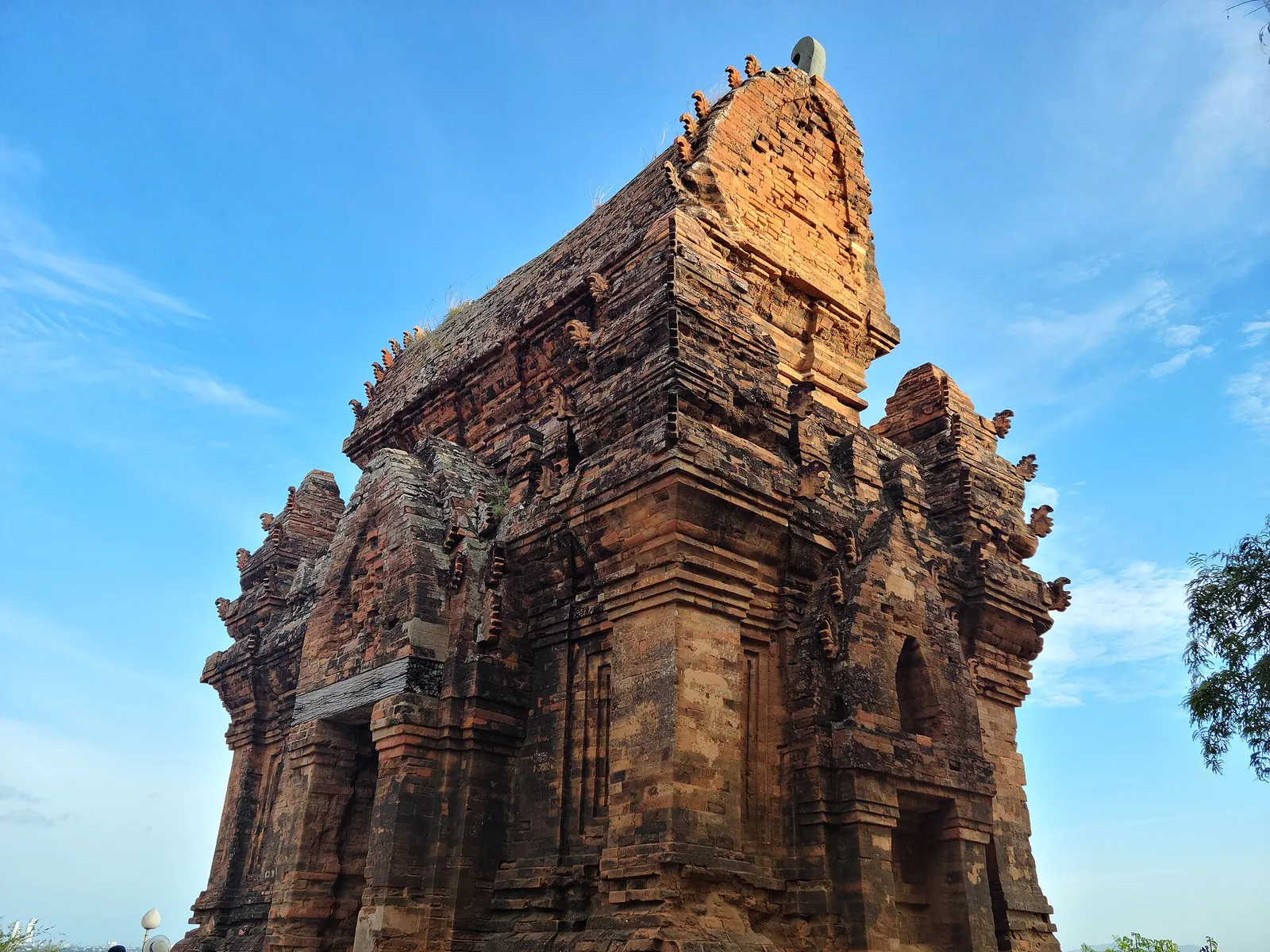 The red-brick main tower of Po Klong Garai against a bright blue sky near Phan Rang
