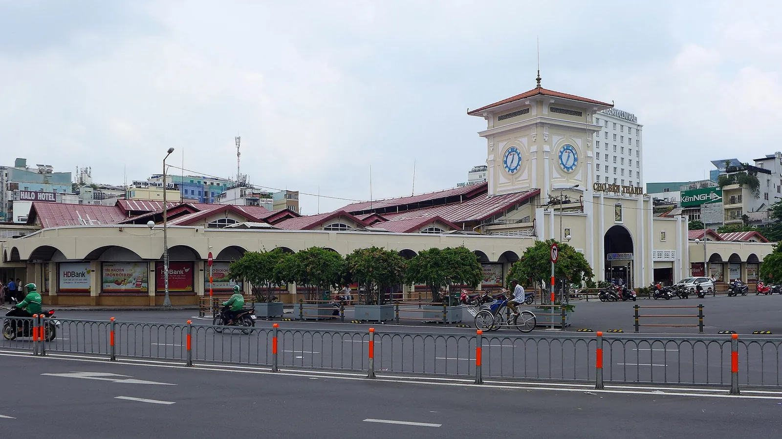 The clock tower and long low facade of Ben Thanh Market seen across the road