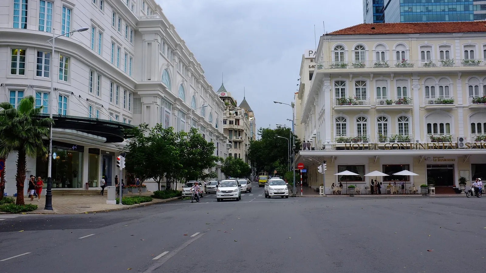 White colonial-era hotel facades on a quiet stretch of Dong Khoi Street