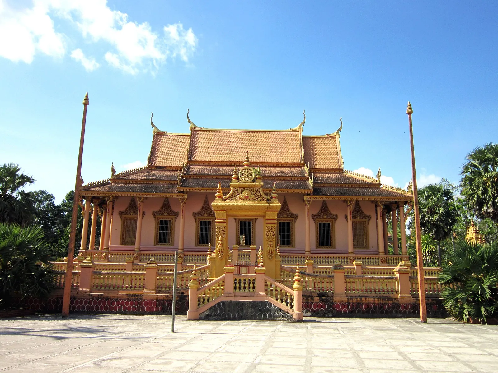 Front of Kh'leang Pagoda in Soc Trang with its tiered orange roofs and a gilded central spire