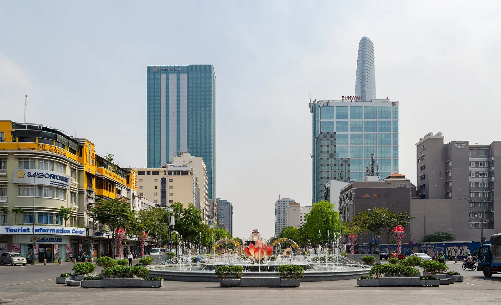 Nguyen Hue Street in Ho Chi Minh City with a fountain, flower beds and the Bitexco Financial Tower