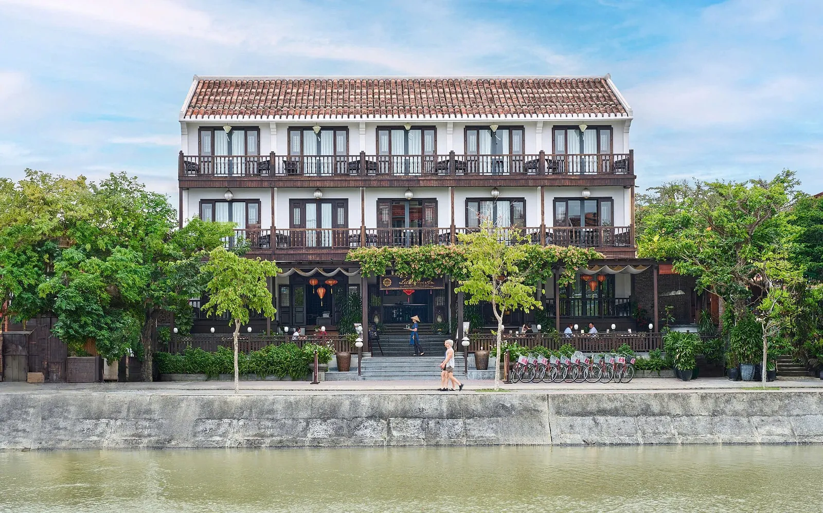 A three-storey boutique hotel with balconies facing the river in Hoi An