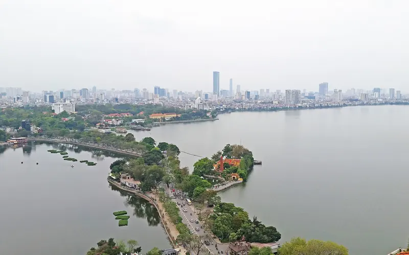 Aerial view of Thanh Nien Road running between West Lake and Truc Bach Lake in Hanoi, with the city skyline behind