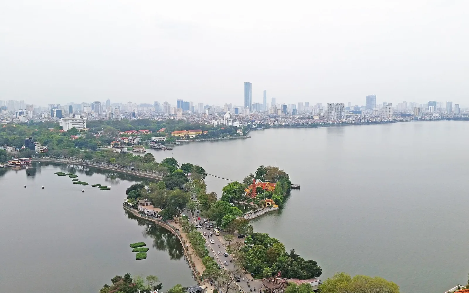 Aerial view of Thanh Nien Road running between West Lake and Truc Bach Lake in Hanoi, with the city skyline behind