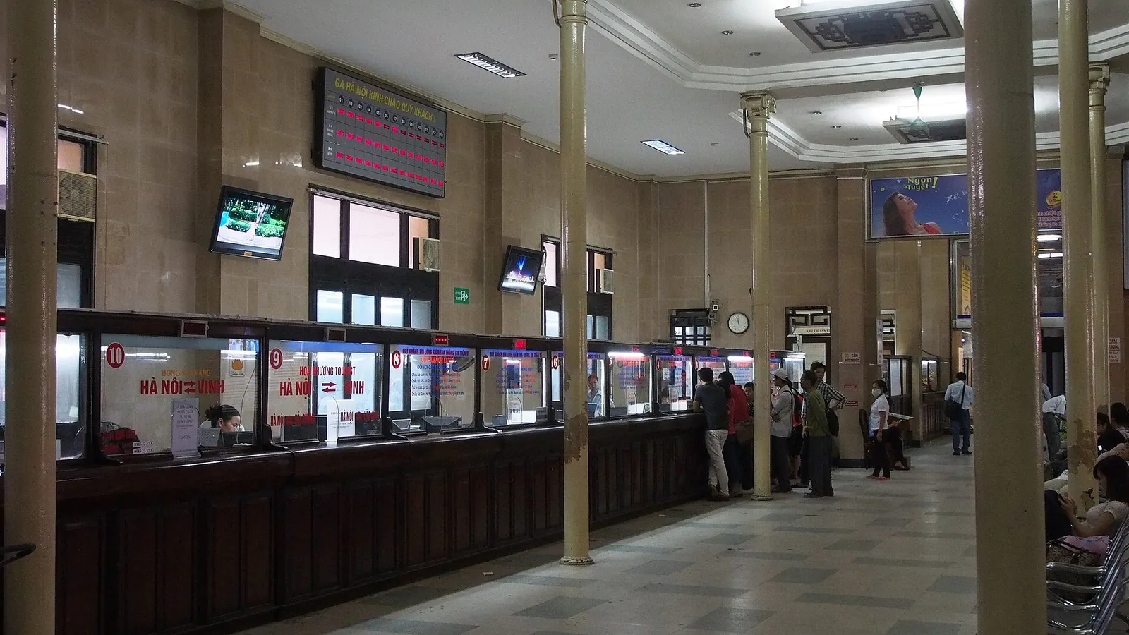 The ticket hall at Hanoi Railway Station with a row of ticket counters and waiting passengers