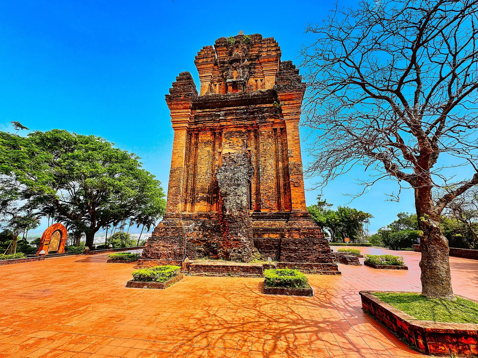 The red-brick Cham tower of Thap Nhan on Nhan Mountain under a blue sky