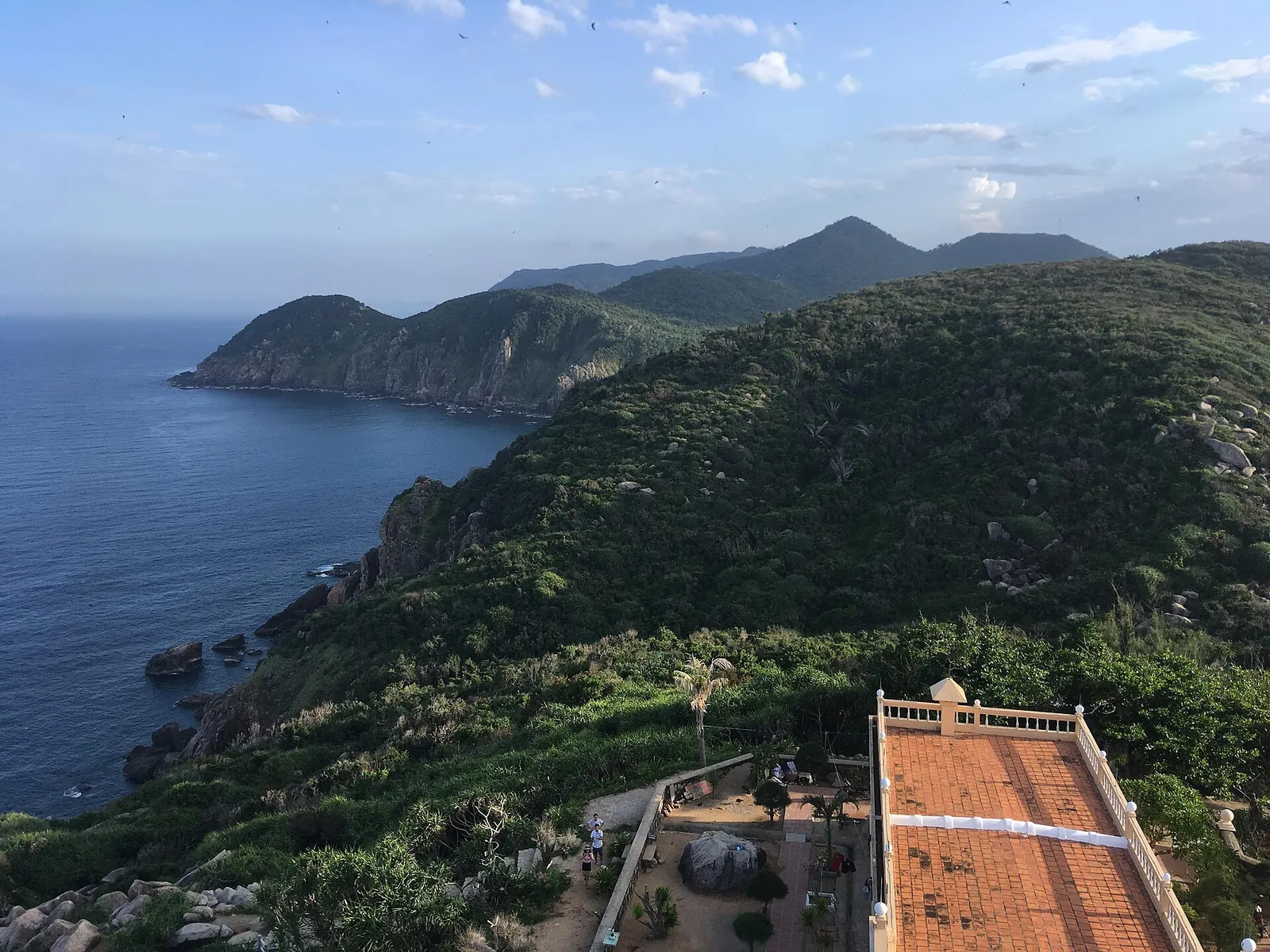 Green headlands and the open sea seen from the lighthouse terrace at Mui Dien
