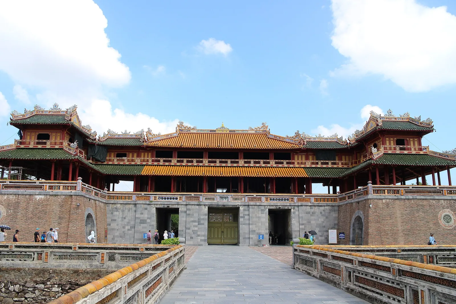 The Meridian Gate of the Imperial City in Hue, with its tiered roofs above the stone gateway under a blue sky