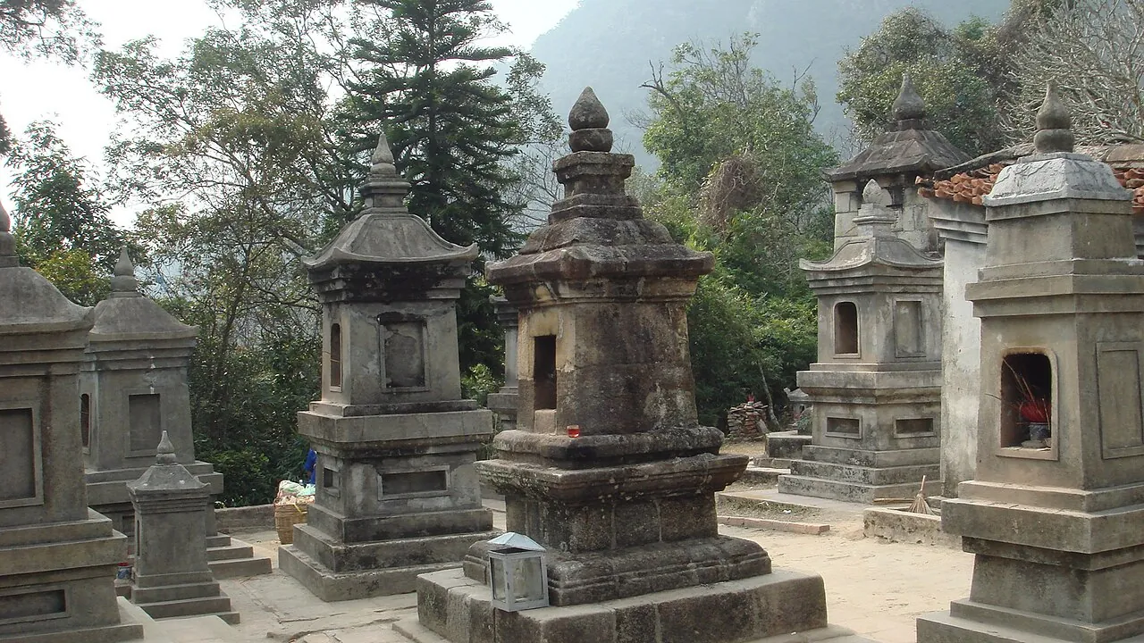 Weathered stone stupas in the Hue Quang stupa garden on Yen Tu Mountain